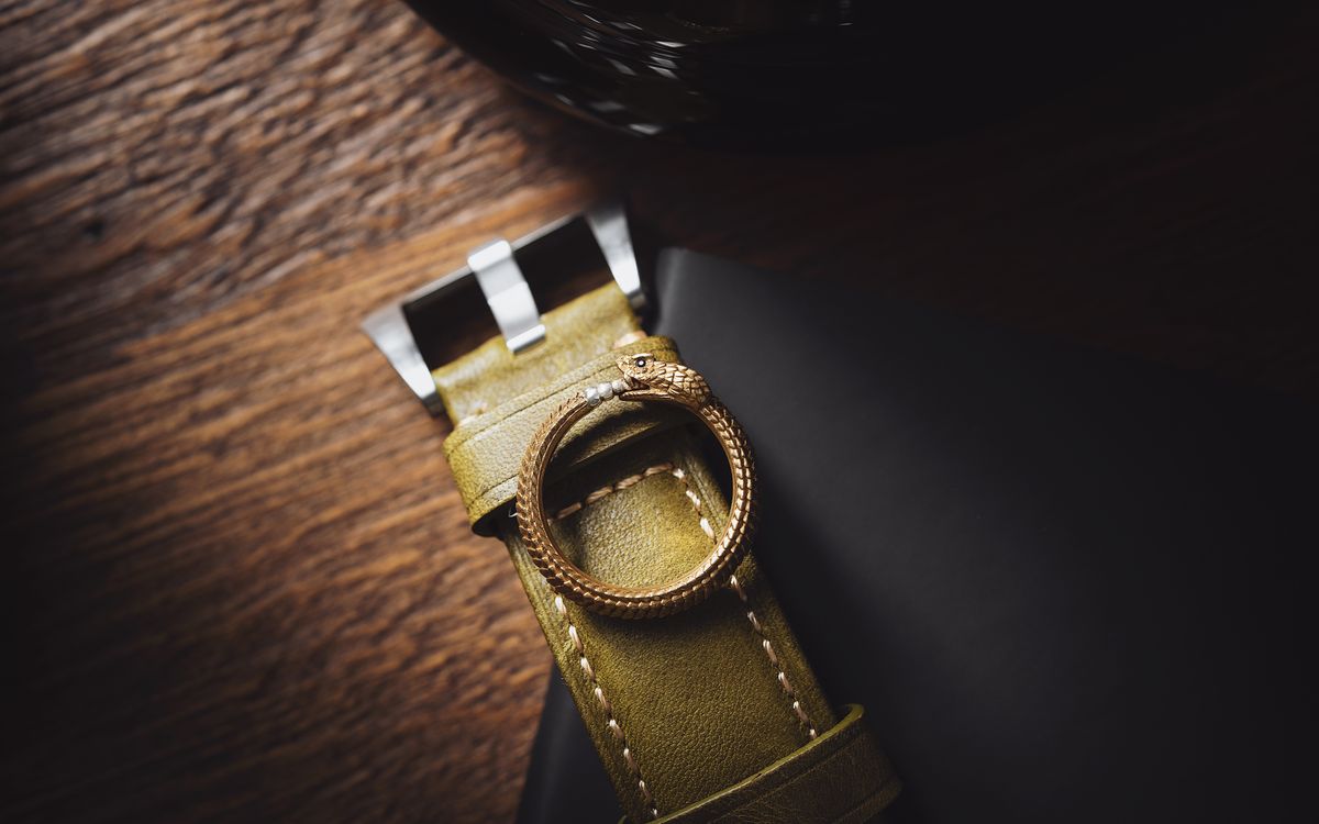 A golden ring resting on a leather belt