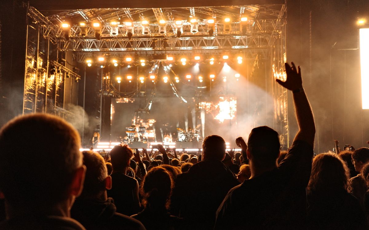 A night concert crowd lit by stage lights