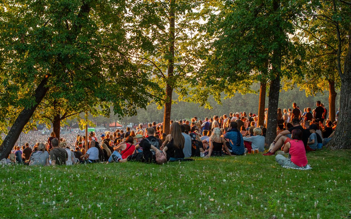 A sunset gathering at an outdoor festival ground