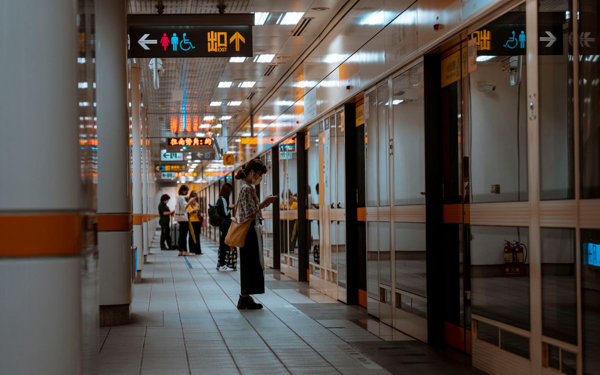 People waiting near the doors at an airport terminal
