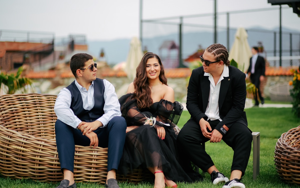 Well-dressed wedding guests standing together at a celebration